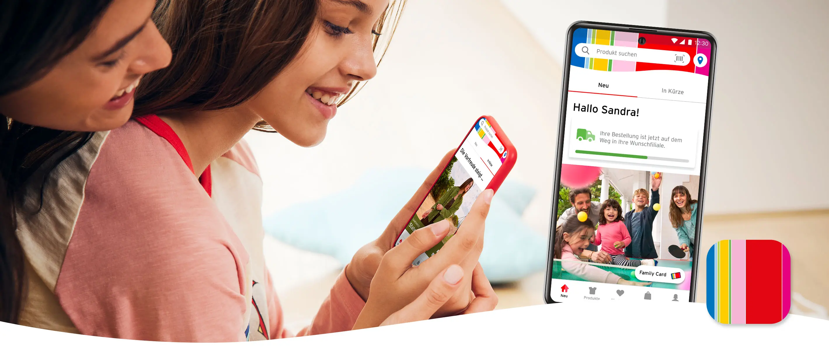 Zwei Mädchen schauen auf die Ernsting's family App.